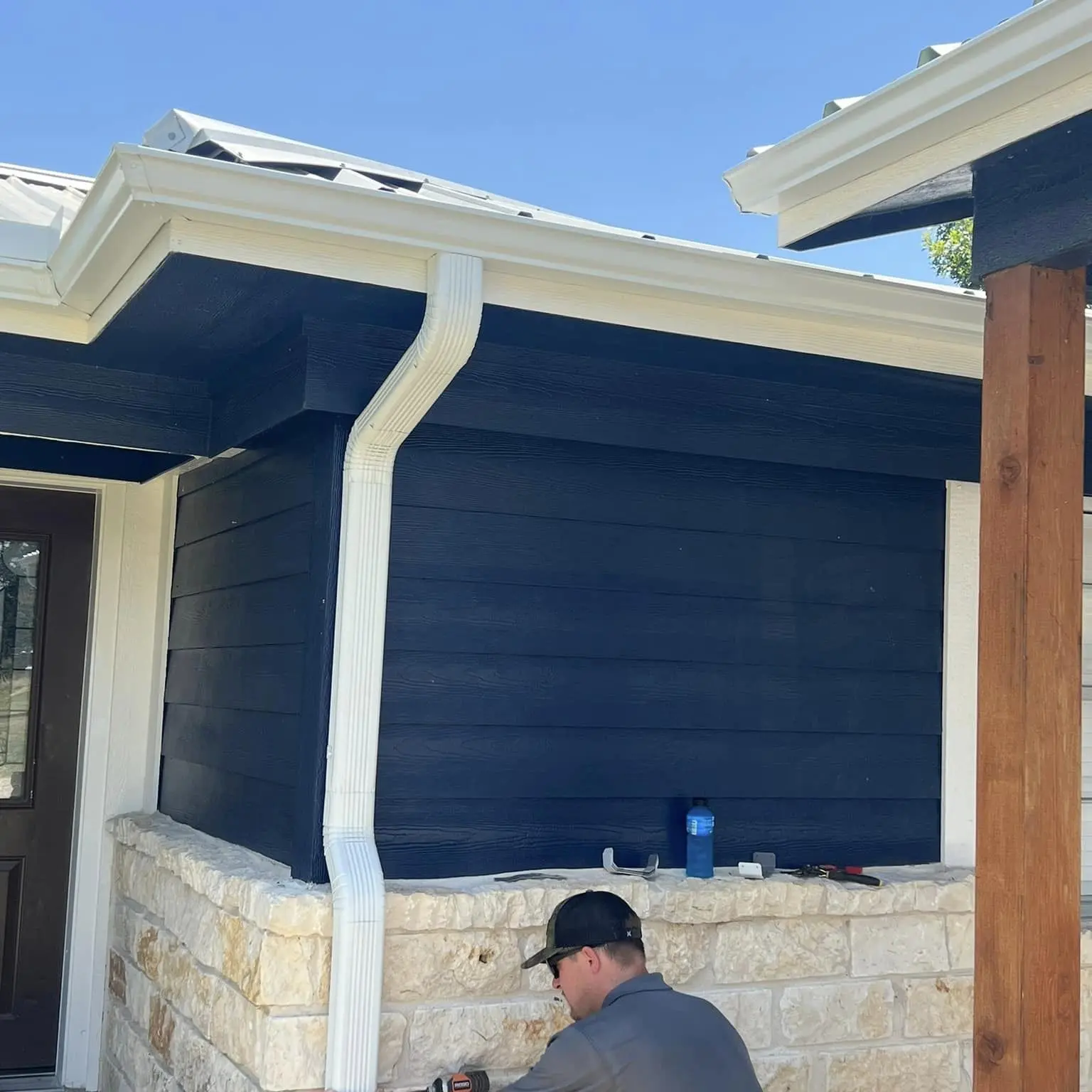 Roof On Texas technician installing seamless gutters with precision for effective water management in Waco, Texas